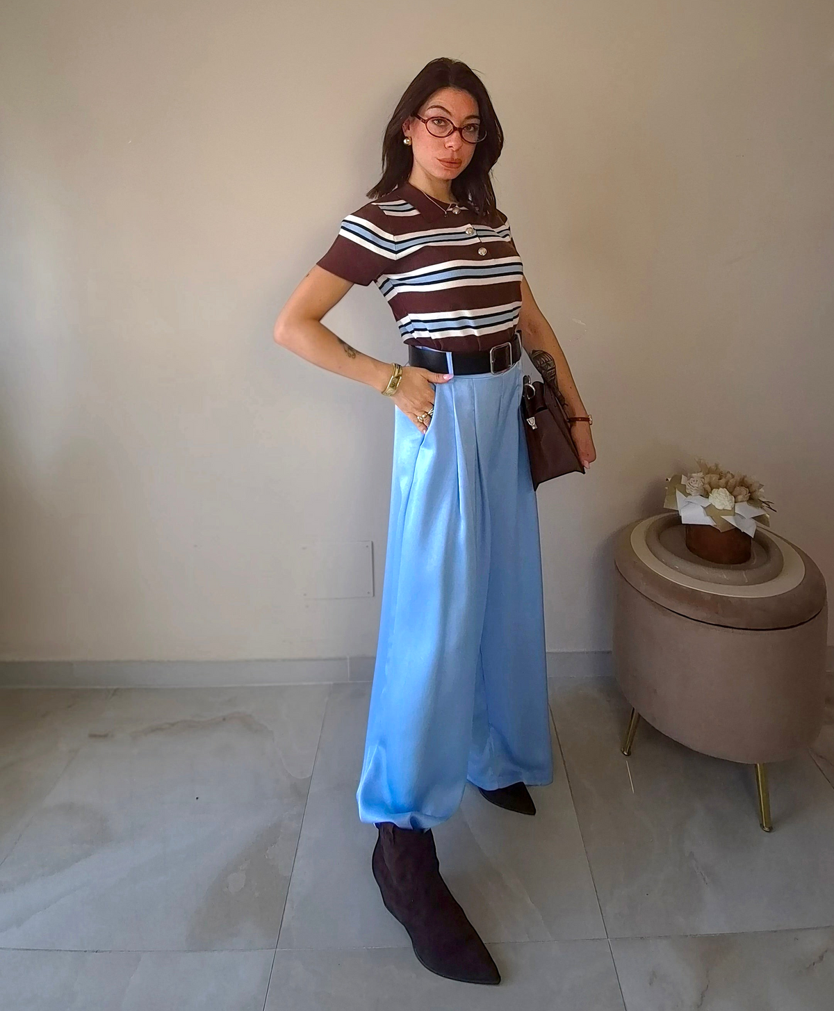Claure Mode light blue satin wide-leg trousers worn by a woman with a striped top and brown boots