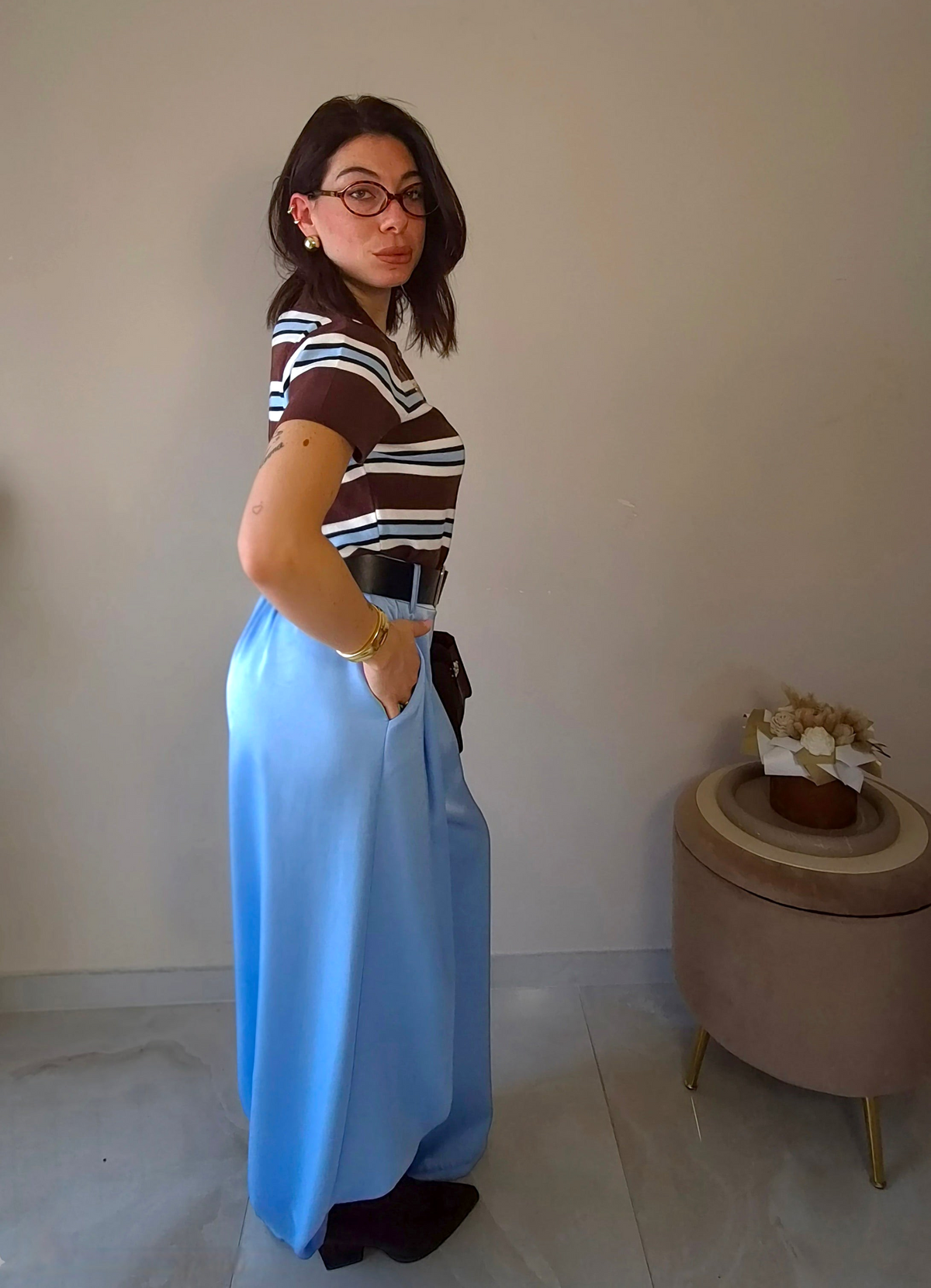Claure Mode light blue satin wide-leg trousers worn by a woman with a striped top and black belt